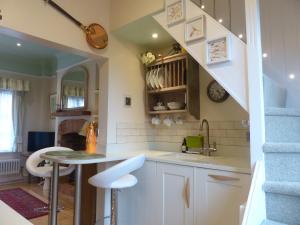 a kitchen with a sink and a table in a room at The Little House in Devizes