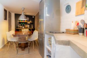 a kitchen with a table and a dining room at Bendita Casa in Granada