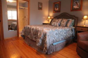 a bedroom with a bed and a window and a couch at A Garden Stroll Bed & Breakfast in Stratford