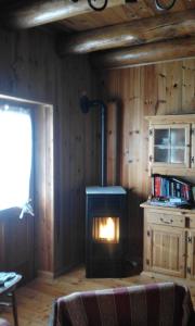 a living room with a woodburning stove in a room at Baita Valtellina in Teglio