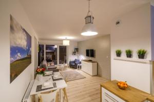 a room with a kitchen and a living room at Apartament z tarasem in Kielce