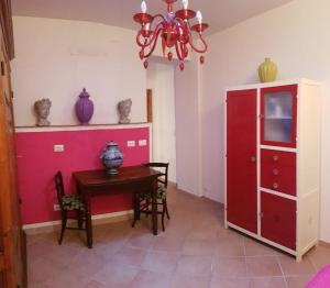 a dining room with a red cabinet and a table at Casa Sophia in Siena