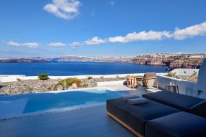 a villa with a pool and a view of the water at Avatar Suites in Akrotiri