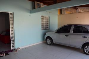 a car parked in a garage next to a building at CASA para até 10 PESSOAS in Boa Vista