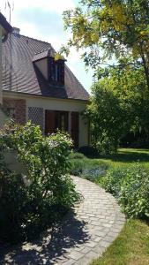 a house with a brick walkway in front of it at Les Prunelliers in Rambouillet