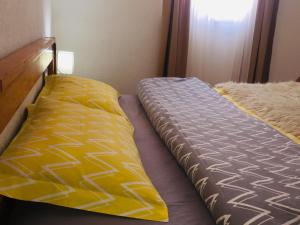 a couple of beds in a room with a bedskirtspectspectspects at Holiday home Nikola in Žabljak