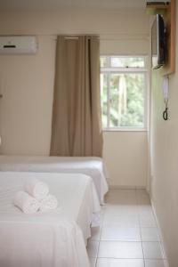 A bed or beds in a room at Hotel Fazenda Pommernland