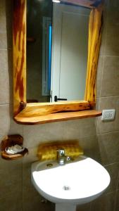 a bathroom with a sink and a mirror at Departamentos de Alquiler Turistico: Familia Eguren in San Carlos de Bariloche