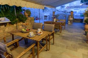 a table with a bowl of fruit on a patio at Athina Guesthouse in Hydra