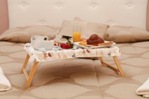a tray of breakfast food on a table on a bed at La Zagara B&B Centro Catania Vicino Duomo in Catania