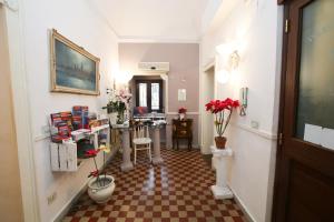 a hallway with a checkered floor in a building at La Zagara B&B Centro Catania Vicino Duomo in Catania
