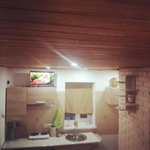 a bathroom with a sink and a tv on the wall at Киевская 43 in Khorol +30 photos