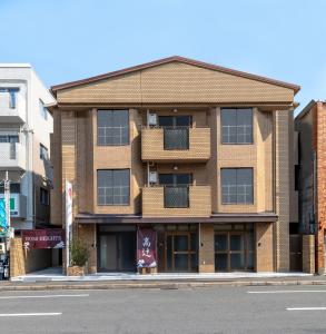 an apartment building on the corner of a street at Kyoto Takatsuji Rose Heights in Kyoto
