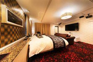 Hotel Eldia Modern Kobe(Adult Only) tesisinde bir odada yatak veya yataklar