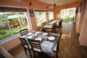 uma fila de mesas e cadeiras num restaurante em Upasana Eco Resort em Bolpur