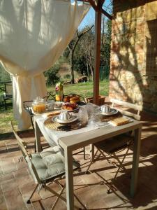 a table with food on it on a patio at Elisabeth House in Lucignano
