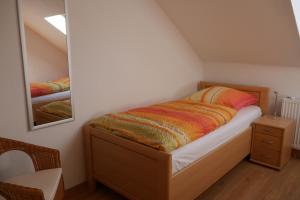a small bedroom with a bed and a mirror at Apartment Fewo Central in Essen