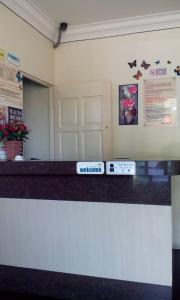 a waiting room with a counter with a sign on it at Hotel Morning Glory in Kudat