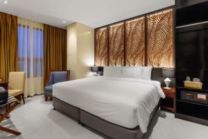 A bed or beds in a room at Summit Hotel Tacloban