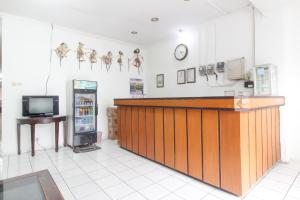 a restaurant with a counter and a tv in a room at RedDoorz near Kranggan Tugu Jogja in Yogyakarta
