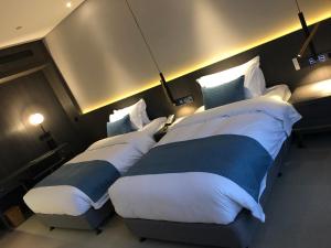 En eller flere senger på et rom på Hangzhou Cosy Park Hotel(Liangzhu)