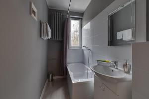 a white bathroom with a sink and a toilet at Apartamenty Old Town Mniszki in Gdańsk