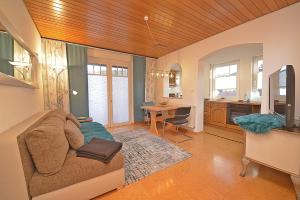 a living room with a couch and a table at Gästehaus Ingrid in Ramsthal