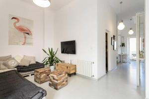 a living room with a couch and a tv at White Loft Alicante in Alicante