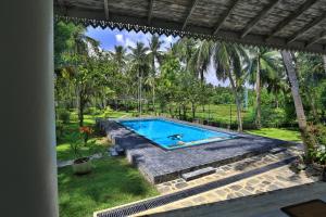 a swimming pool in the backyard of a house at Amara Villa in Galle