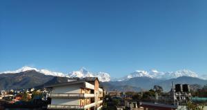 a view of a city with mountains in the background at Hotel Mountain View - Lakeside Pokhara in Pokhara