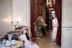 a woman standing in a room with two girls in a room at Angel Wings Inn in Hualien City