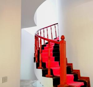 - un escalier rouge dans une chambre avec un mur blanc dans l'établissement Santa Victoria House, à Chiclayo