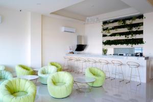 a bar with neon green chairs and a counter at Little Piggy B&B in Manzhou