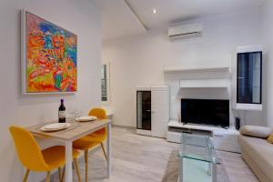 a living room with a table and a couch at Modern Apartment 20 meters from the Promenade in Sliema