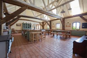 a large room with tables and chairs in a building at Convivium Transilvania in Criţ