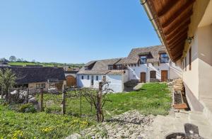 a row of white houses in a village at Convivium Transilvania in Criţ