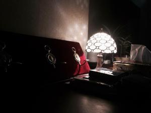 a lamp sitting on a table in a dark room at Angel Wings Inn in Hualien City