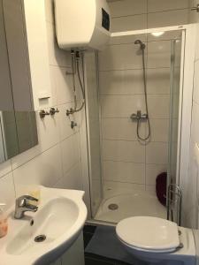 a bathroom with a shower and a sink and a toilet at Apartmani Mia in Trogir