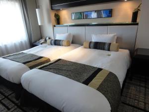 Letto o letti in una camera di Hotel Granvia Hiroshima