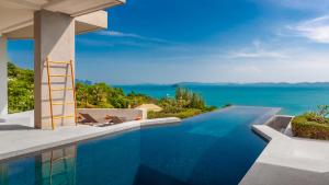a swimming pool with a view of the ocean at Villa Leelawadee in Por Bay