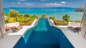 a swimming pool with a view of the water at Villa Leelawadee in Por Bay