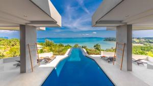 a villa with a swimming pool and a view of the ocean at Villa Leelawadee in Por Bay