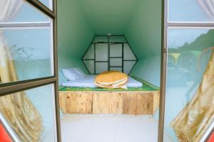 a small room with a bed in the middle at Eco House Mộc Châu in Mộc Châu