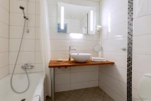 a bathroom with a sink and a shower at Havila Hotel Geiranger in Geiranger