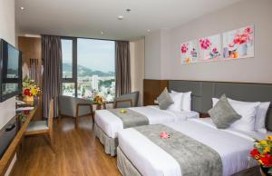 Un ou plusieurs lits dans un hébergement de l'établissement DTX Hotel Nha Trang