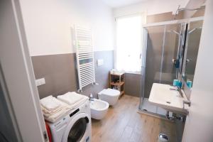 a bathroom with a washing machine and a sink at Laura's Home - I Navigli Che Vorrei in Milan