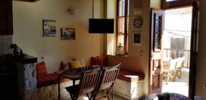 a room with a table and chairs and a balcony at Mika's House in Halki