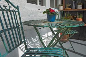 une table et une chaise vertes avec une plante en pot dans l'établissement The Old Farm House, à Hereford
