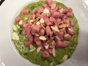 a bowl of soup with ham and green sauce at Agriturismo Montorso in Monte Rinaldo