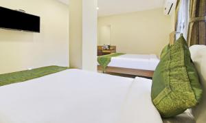 Letto o letti in una camera di Itsy Hotels Jansi Residency